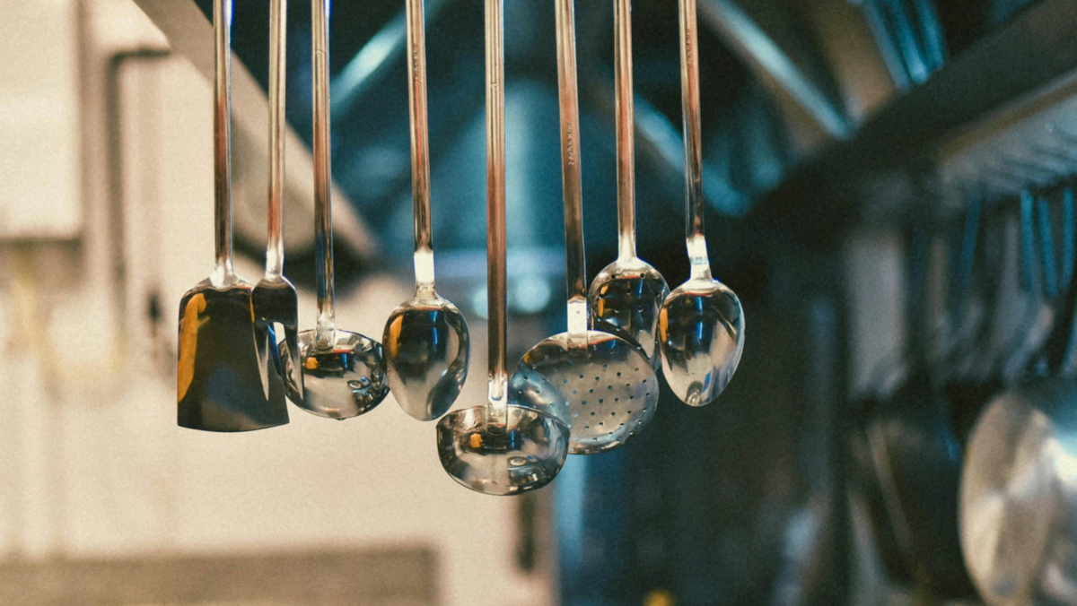 Chef slicing rotisserie chicken behind the counter at Five Rivers Rotisserie