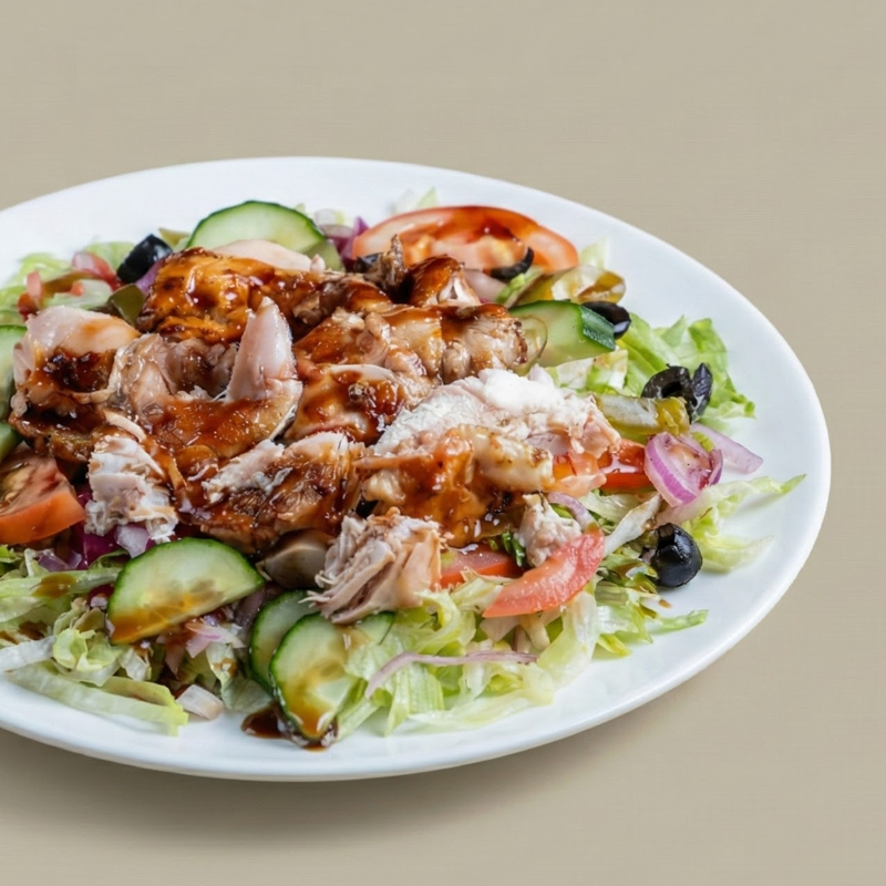 Green salad topped with shredded rotisserie chicken