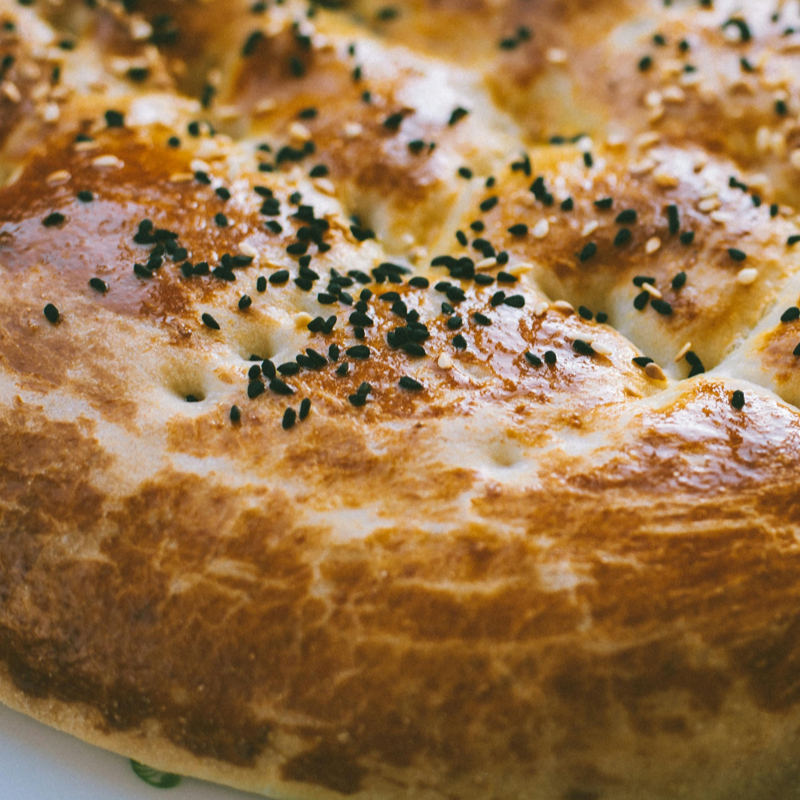 Slice of fluffy Turkish bread sprinkled with sesame seeds